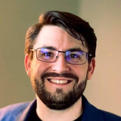 Smiling man with glasses and beard.